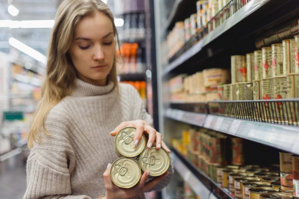 Woman Buys Stew In Cans In A Supermarket Provisio 2022