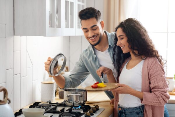 Happy Young Couple Cooking Healthy Food On Gas Stove Propane Clean Gas